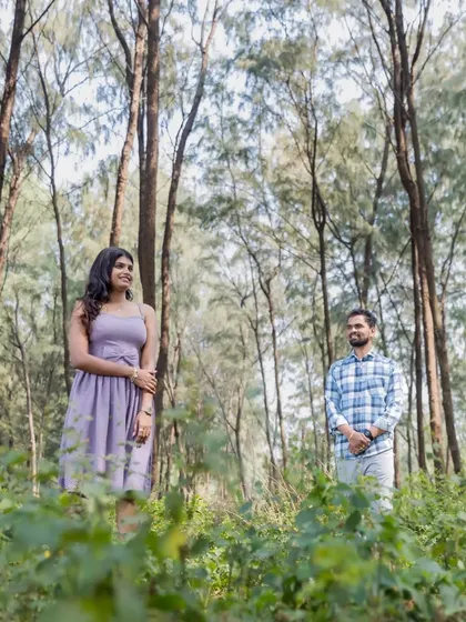 A wide shot of the couple in a beautiful forest, showcasing the scale and beauty of a nature-themed pre-wedding photoshoot.