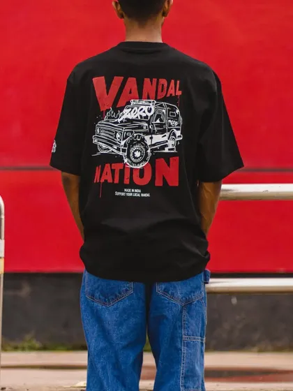 A full shot of the T-shirt being worn, showing how the oversized fit and graphic look in a real-world context.