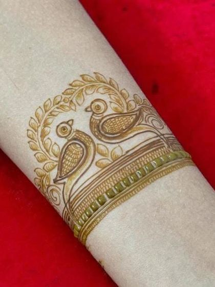 The bird armband design after the first layer of filling, showing how the pattern starts to take shape.