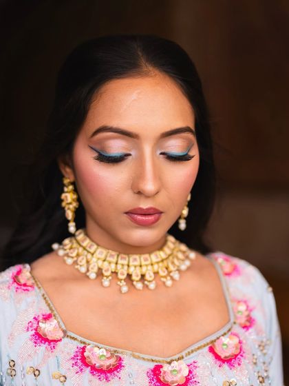 A close-up of the pastel blue winged liner created for a carnival-themed event. It's a fun and playful way to add a pop of color that ties in with a unique outfit.