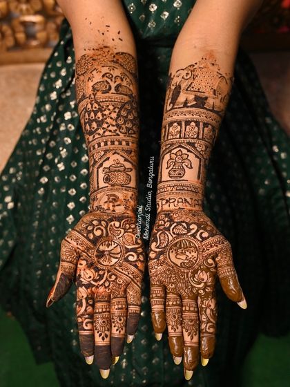 This bridal mehendi features the bride's name 'Poorna' beautifully integrated into the design, surrounded by peacocks, elephants, and a traditional kalash.