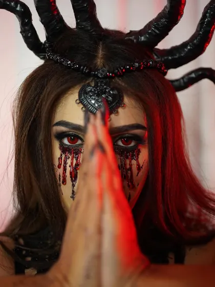 We also dive deep into the world of creative and special effects makeup. This look explores darker themes, using techniques to create realistic textures like tears of blood, perfect for fantasy photoshoots or character work.