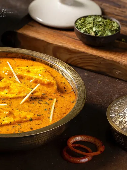 A side angle of the Paneer-e-Rubaruh, showing the dish with traditional serveware.
