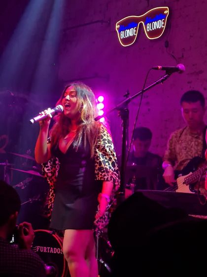 Singing my heart out under the purple lights. Performing at venues like antiSOCIAL allows us to connect with a true music-loving audience.