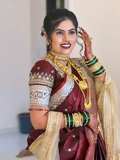 A beautiful candid shot of the bride. Her soft curls and the floral accessory in her hair add a touch of modern elegance to the traditional look.