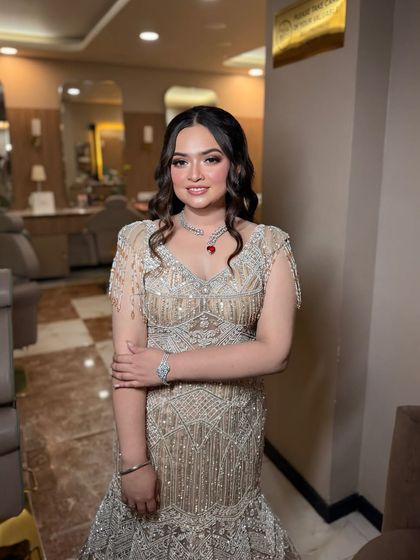 A full-length view of this stunning engagement gown. The makeup and hair were designed to complement the elegant, shimmering dress.
