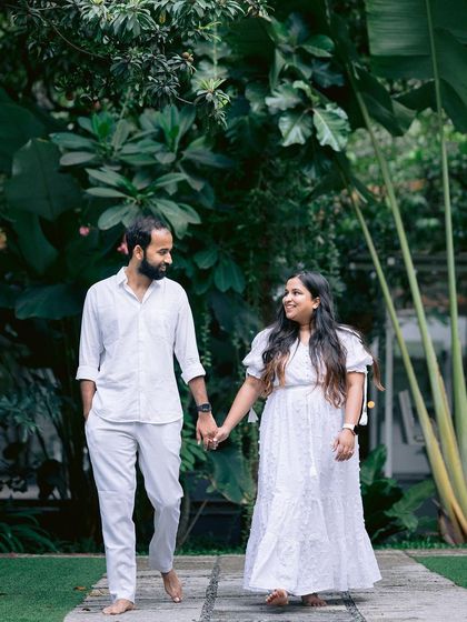 A couple enjoying a quiet moment during their pre-wedding shoot. Walking barefoot on our stone path, they are surrounded by the peaceful greenery of the venue.