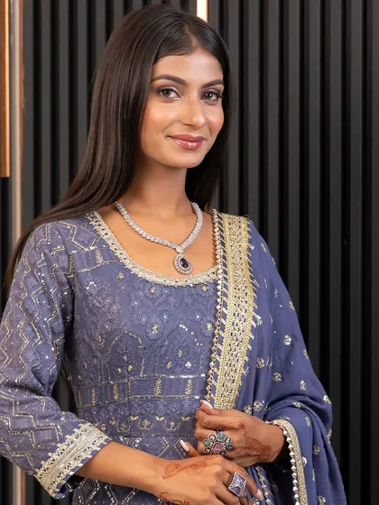 A detailed view of a beautiful necklace and earring set, worn by a client in our blue Anarkali gown. Renting allows you to wear luxurious jewellery without the investment.