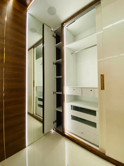 Here you can see a special pull-out shelf we added inside the wardrobe. It's perfect for organizing smaller items or accessories that might otherwise get lost.