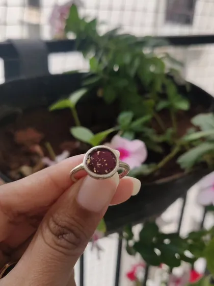 This matching jewelry set, a heart-shaped pendant and a ring, was created using a client's preserved rose petals. It's a beautiful way to keep a sentimental flower close to your heart.
