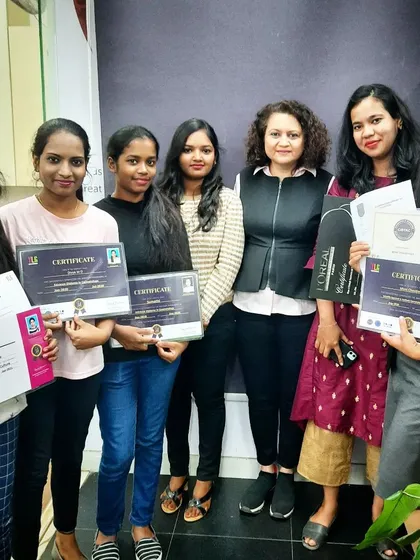 A group of graduates from our various beauty programs, including nail artistry, holding their certificates. We offer a comprehensive education for a complete career in cosmetology.