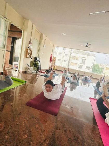 The class works on the Bow Pose, a powerful posture for opening the entire front of the body. With regular practice, students build the strength and flexibility needed for this deep backbend.