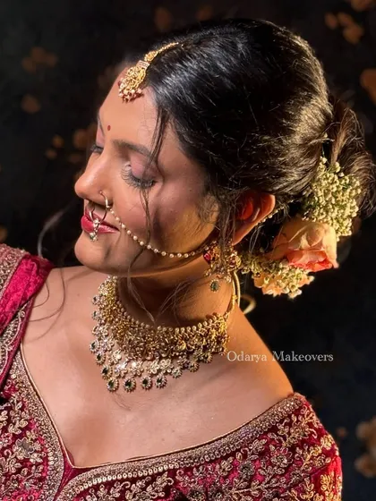 A close-up of the bridal bun adorned with fresh roses and baby's breath. I believe the hairstyle is just as important as the makeup for the complete bridal look.
