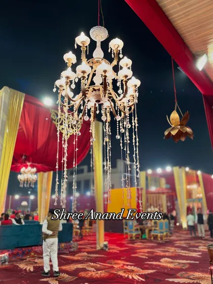 A close-up of a beautiful crystal chandelier with cascading bead strings, a timeless element of luxury in our event designs.