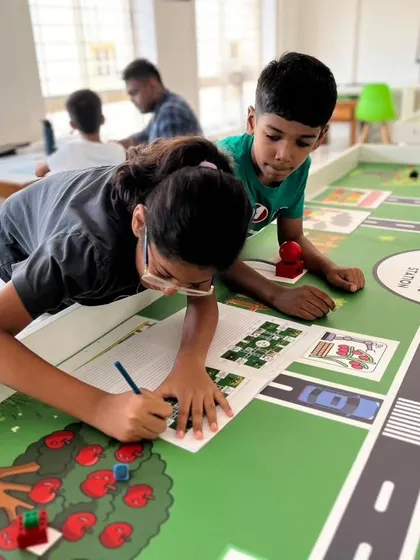 Our students are deep in preparation for the Indian Robotics Olympiad 2024. Here, they are strategizing on the "Harvest Heroes" challenge mat, figuring out the most efficient way to complete their missions.