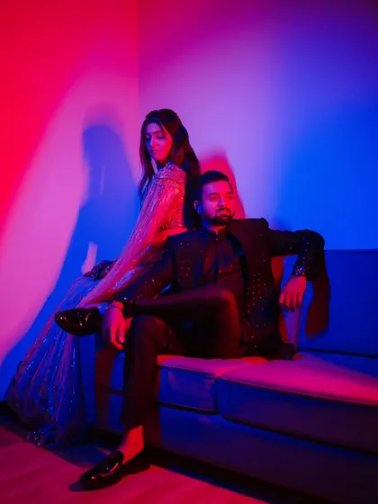 A bold and modern portrait using red and blue colored gels. This lighting technique creates a vibrant, high-fashion look that is perfect for couples wanting something edgy and artistic.
