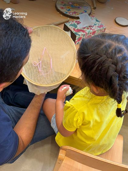 This image, identical to 66, reinforces the importance of parent-child connection. Shared creative moments are powerful opportunities for bonding and mutual understanding.