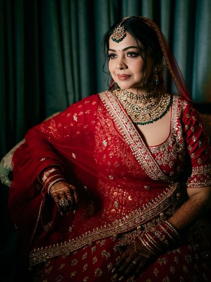 An elegant seated portrait of the bride, showcasing her poise and the rich details of her wedding attire.