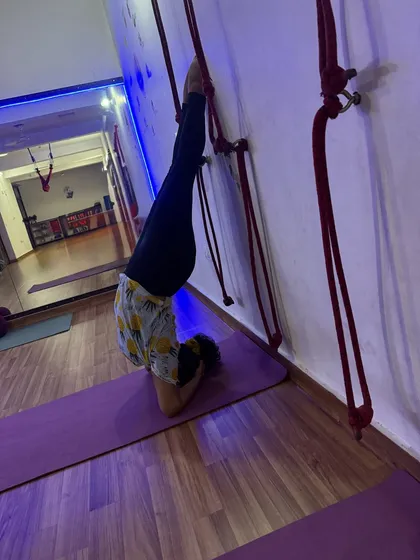 A supported headstand using the wall ropes. This is a fantastic way to get the benefits of inversions without any pressure on the neck.