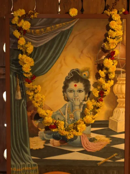 A beautiful painting of Lord Krishna, adorned with fresh flowers as part of our Vishu celebrations. We honor these traditions to bring blessings and positive energy to our space.