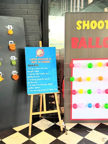 Another view of the game stalls, showing the "Shoot the Balloon" and punch-board games ready for action. These activities are a great way to keep guests of all ages entertained.
