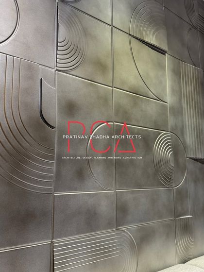 Another perspective of the geometric milled accent wall. The play of light and shadow across the antique silver finish creates a dynamic and ever-changing surface.