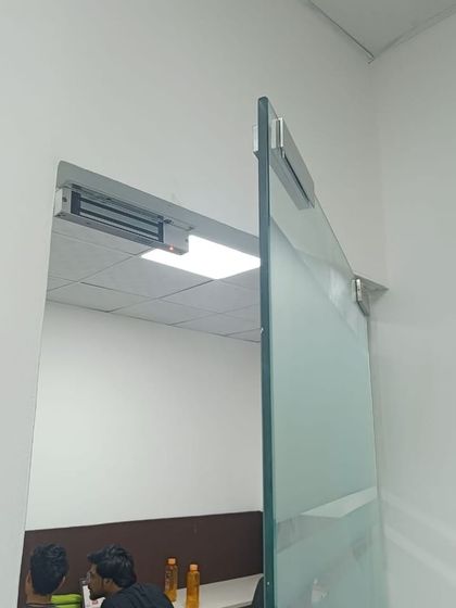 A view of the glass door with the EM lock system installed. This setup is common in corporate offices to restrict access to certain departments.