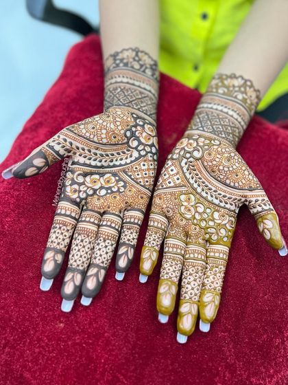 This shot shows the symmetry of the engagement design across both hands. The patterns are elegant and perfect for a bride who loves classic floral motifs.