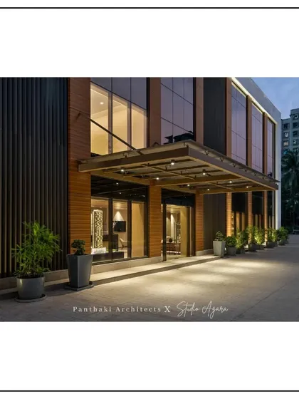 A wider view of the Thane office entrance, showcasing the clean lines and the interplay of wood, glass, and metal that define its contemporary architectural style.