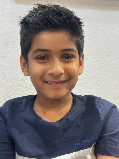 A happy smile from another satisfied young client. This textured cut is modern and easy to style.