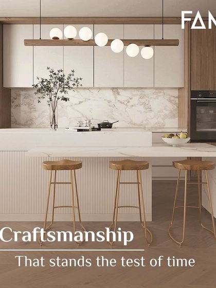 Craftsmanship that stands the test of time. This beautiful kitchen features a white waterfall island with fluted detailing, paired with light wood cabinets and a marble backsplash for a look that is both modern and timeless.