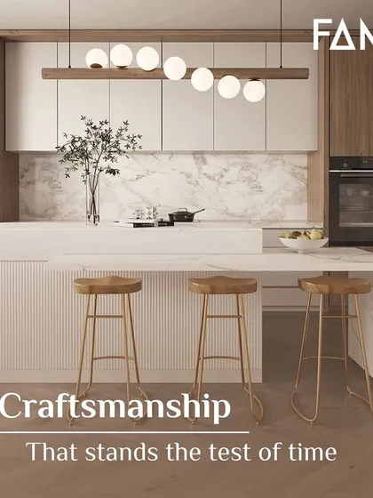Craftsmanship that stands the test of time. This beautiful kitchen features a white waterfall island with fluted detailing, paired with light wood cabinets and a marble backsplash for a look that is both modern and timeless.