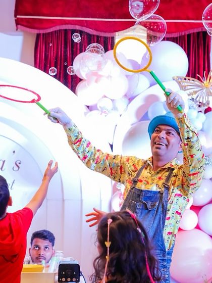 A child gets to participate in the bubble show, trying to create his own giant bubble. I love incorporating interactive elements into the entertainment.