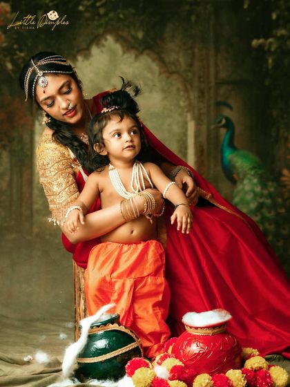The mother's loving gaze at her child tells a story as old as time in this beautifully styled Krishna-themed portrait.