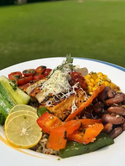 A deconstructed bowl featuring grilled paneer, kidney beans, corn, cucumber, and other fresh vegetables. This dish offers a healthy, protein-packed, and fully customizable meal for guests.