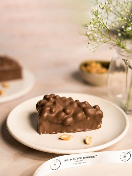 What if a Snickers bar was a pastry? We made it happen. This dessert features a peanut butter cheesecake base, a layer of caramel, and a crunchy peanut and chocolate topping.