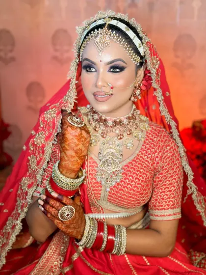 A detailed shot of the bridal makeup. The focus is on the flawless skin finish and the way the makeup enhances her natural beauty without looking heavy.