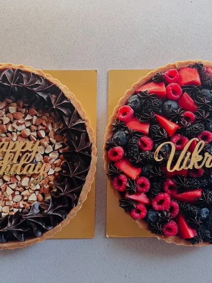 Can't decide? I've got you covered. Here are two of my popular tarts side-by-side: the Dark Chocolate Almond Praline and the Dark Chocolate Mixed Berry, both personalized for a birthday.