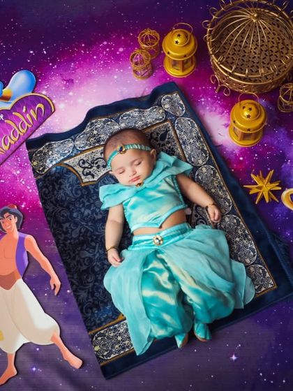Sleeping peacefully on her magic carpet. Our custom newborn Jasmine costume is crafted from soft, baby-safe fabrics to ensure your little one is comfortable during her first photoshoot.
