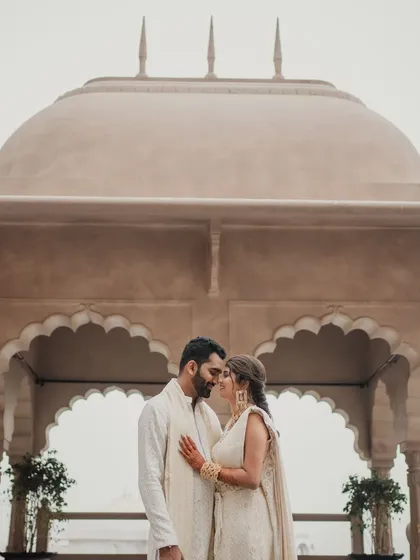 The couple framed by the beautiful arches of the Fairmont Jaipur. We use the venue's best features to create stunning photographic moments.