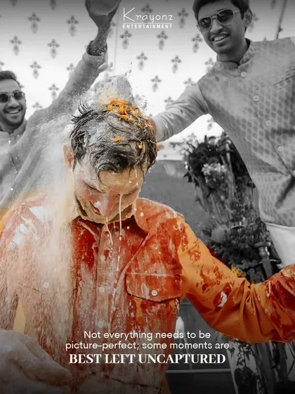 Not everything needs to be picture-perfect. A fun, messy moment from a Haldi ceremony, where the groom is playfully doused by his friends.