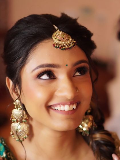 A candid, happy moment from Nony's Mehendi. The earthy tones and defined eyes look beautiful in natural light, showcasing a look that is both traditional and effortlessly chic.