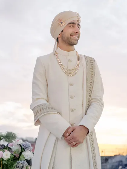 The groom waits, his face filled with emotion, as the sun sets over Turkey. We do it all for this moment, when time slows and he sees his bride walking toward forever.