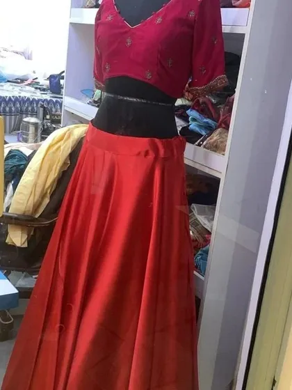 This red skirt is paired with an embroidered velvet blouse, creating a rich, classic lehenga set. It's a great example of how I mix and match pieces for my clients.