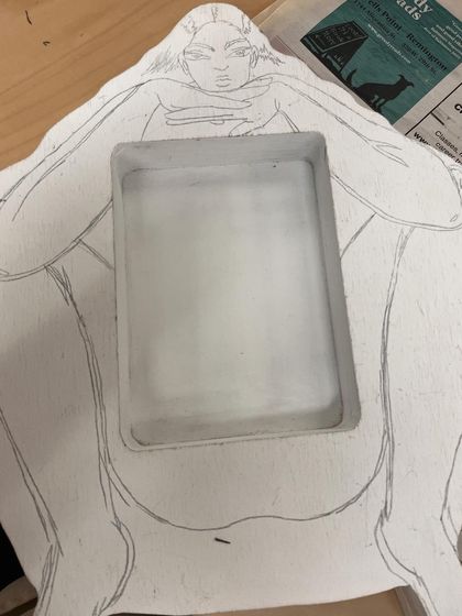 The initial pencil sketch on the wooden form before painting began.