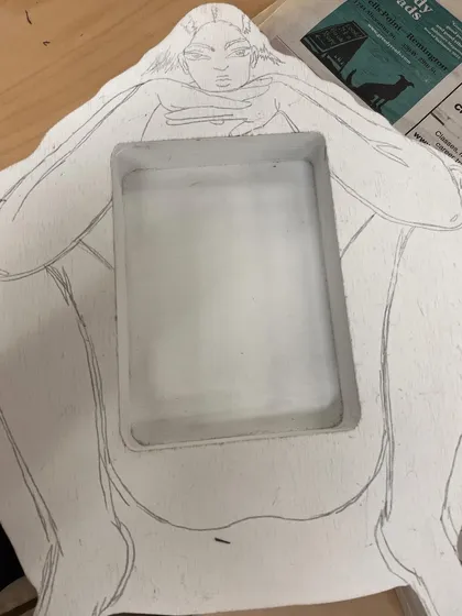 The initial pencil sketch on the wooden form before painting began.