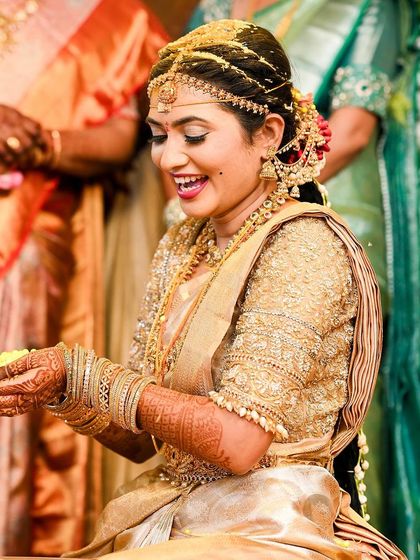 Another joyful moment from Rakshita's wedding, highlighting her radiant smile and flawless makeup.