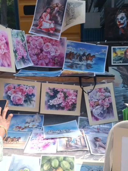 A display of my various watercolor paintings at the Chithra Santhe. You can see a range of subjects, from floral art to landscapes, which are all part of the foundational skills we build for portraiture.