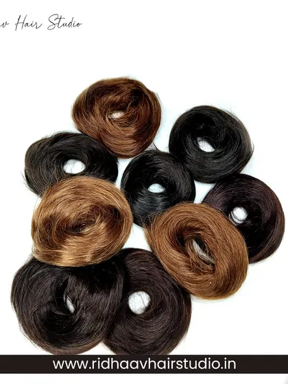 A collection of our human hair scrunchies in various shades of black, brown, and light brown. Mix and match to complement your hair color and style.