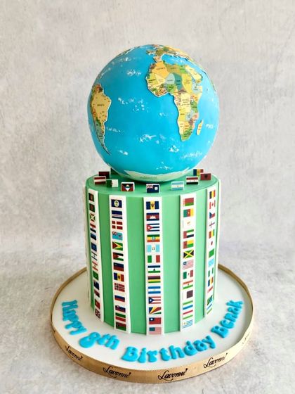 A "Countries of the World" cake for Benak's 8th birthday. The cake is topped with a hand-painted globe and decorated with the flags of many different nations.